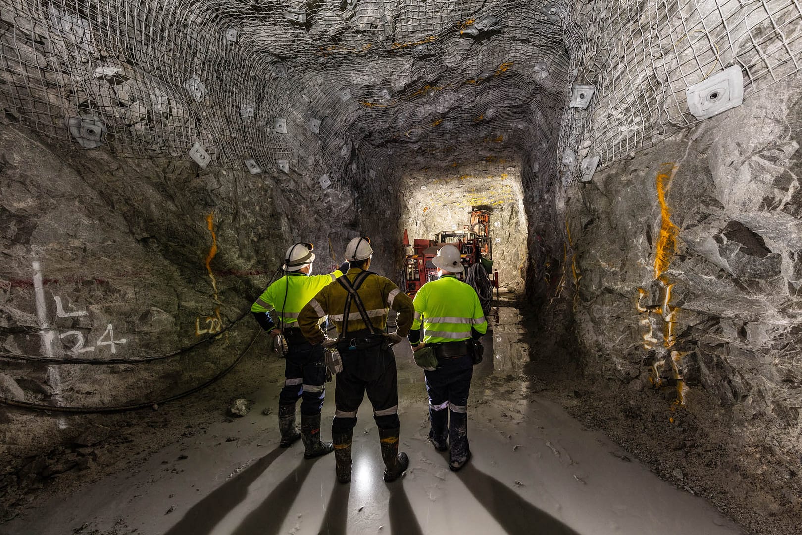 Miners underground inspecting work in progress at a mine site in